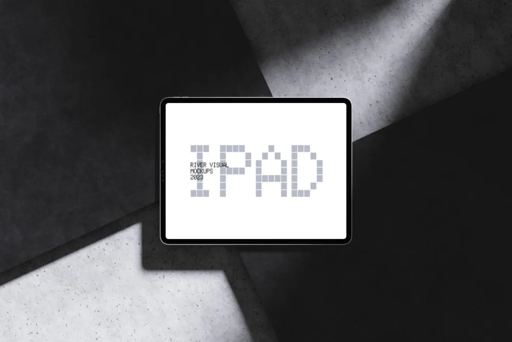 A sleek tablet displayed flat on a surface, with a modern bezel-less design. The background features geometric black and green panels, illuminated by soft, angled lighting for a stylish effect.