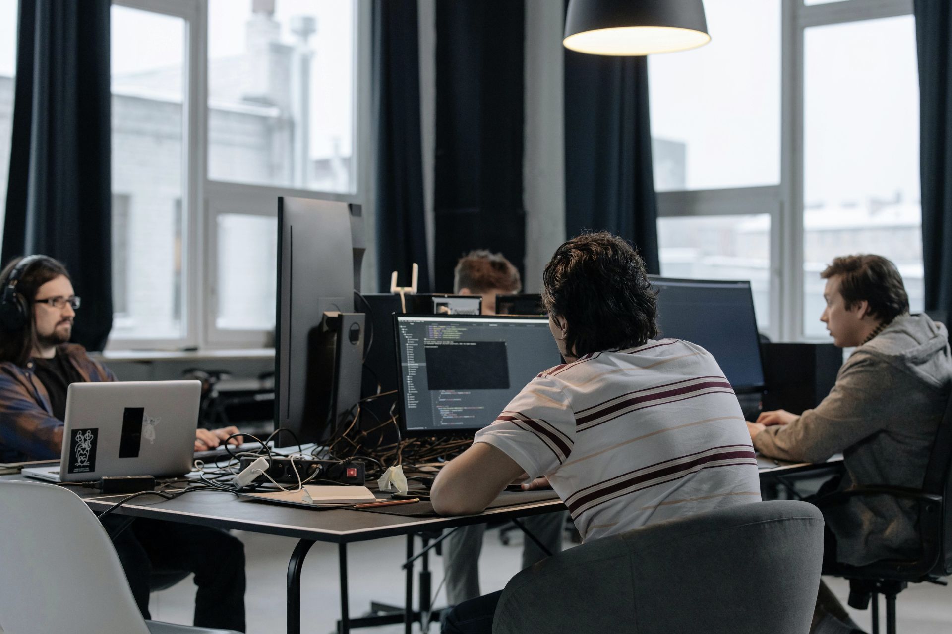 Team of software engineers writing code and developing AI algorithms in a tech hub