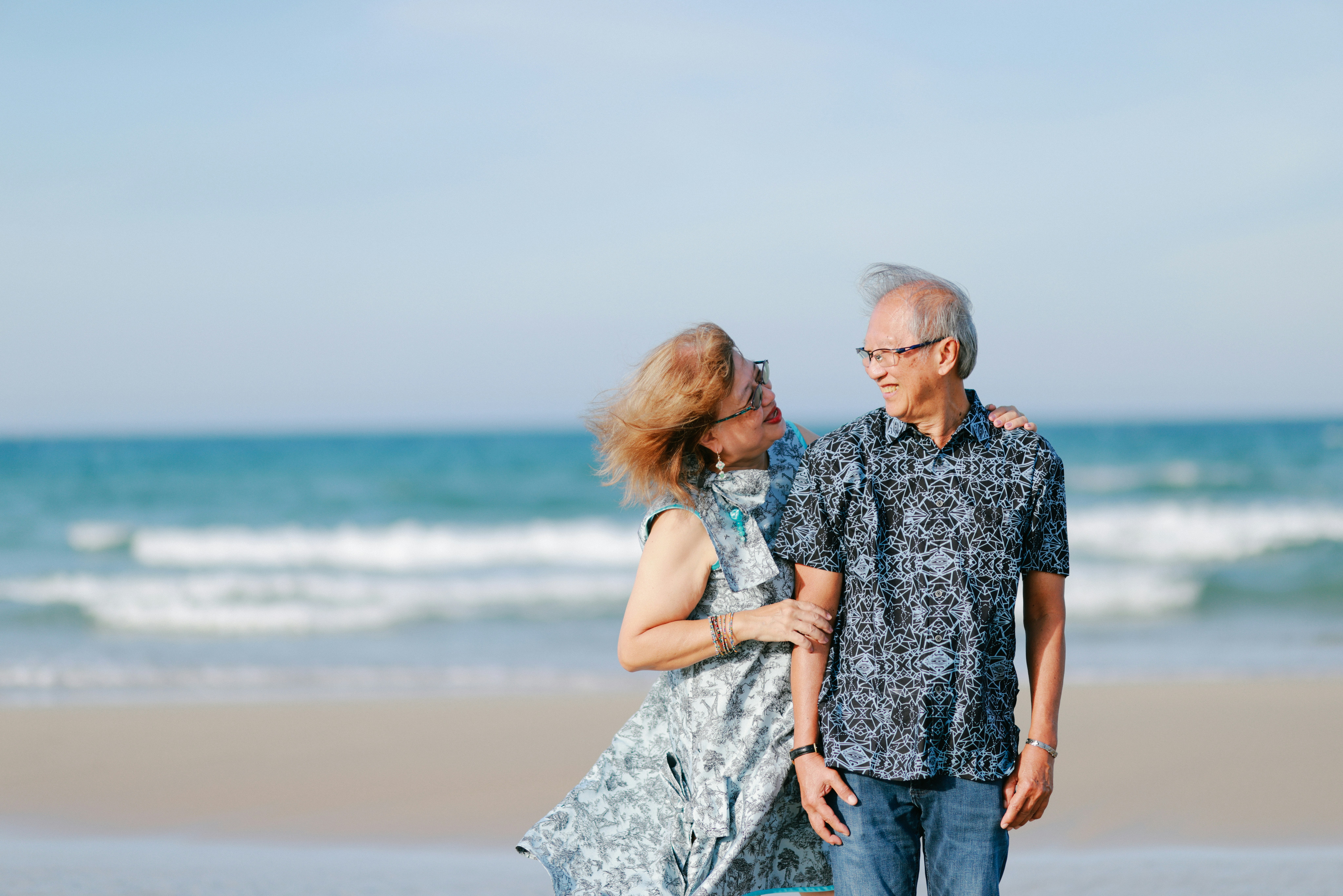 Elderly couple walking on a beach