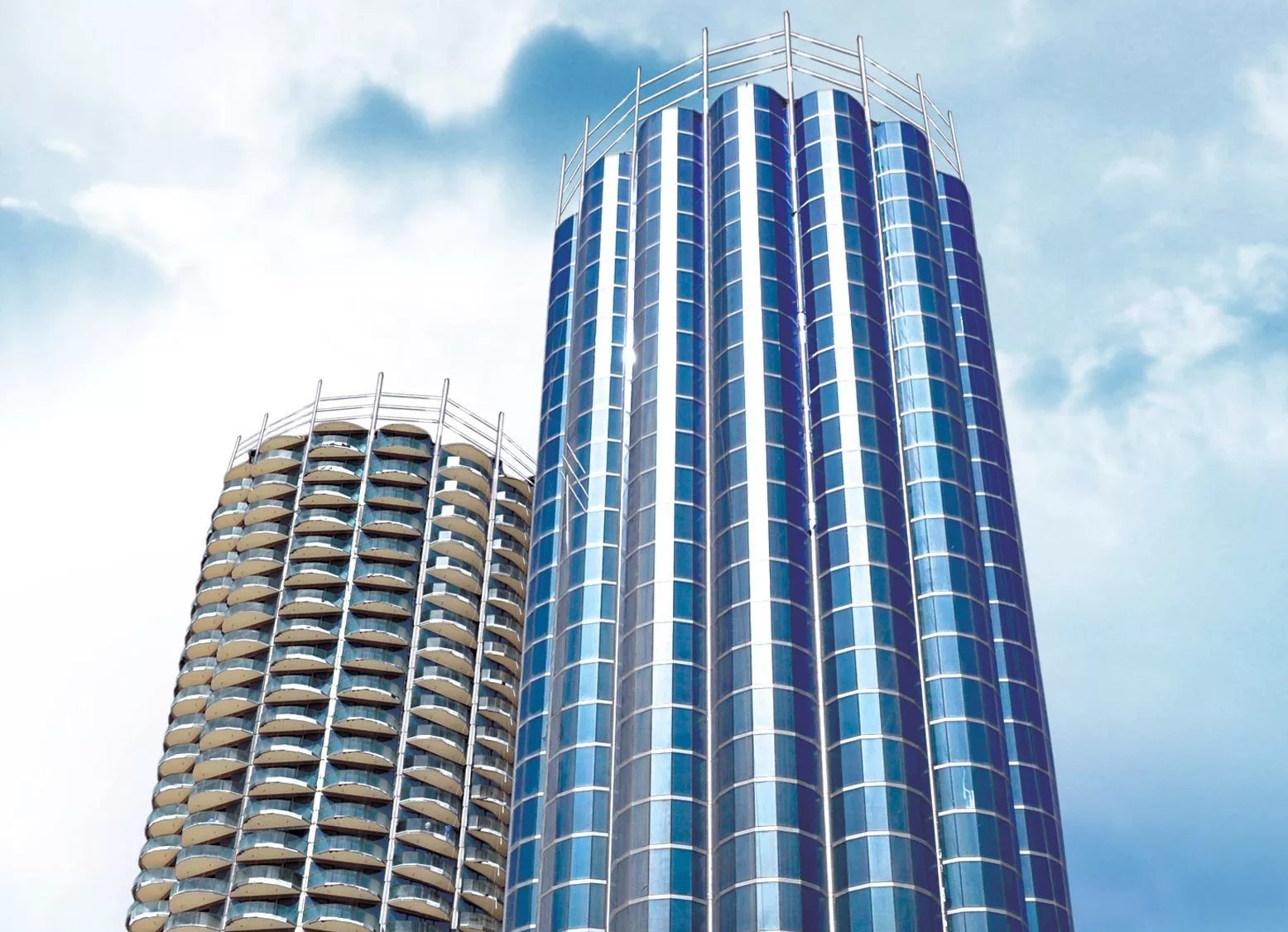 Bright view of Donna Towers twin skyscrapers under a clear blue sky, ideal for premium real estate listings.