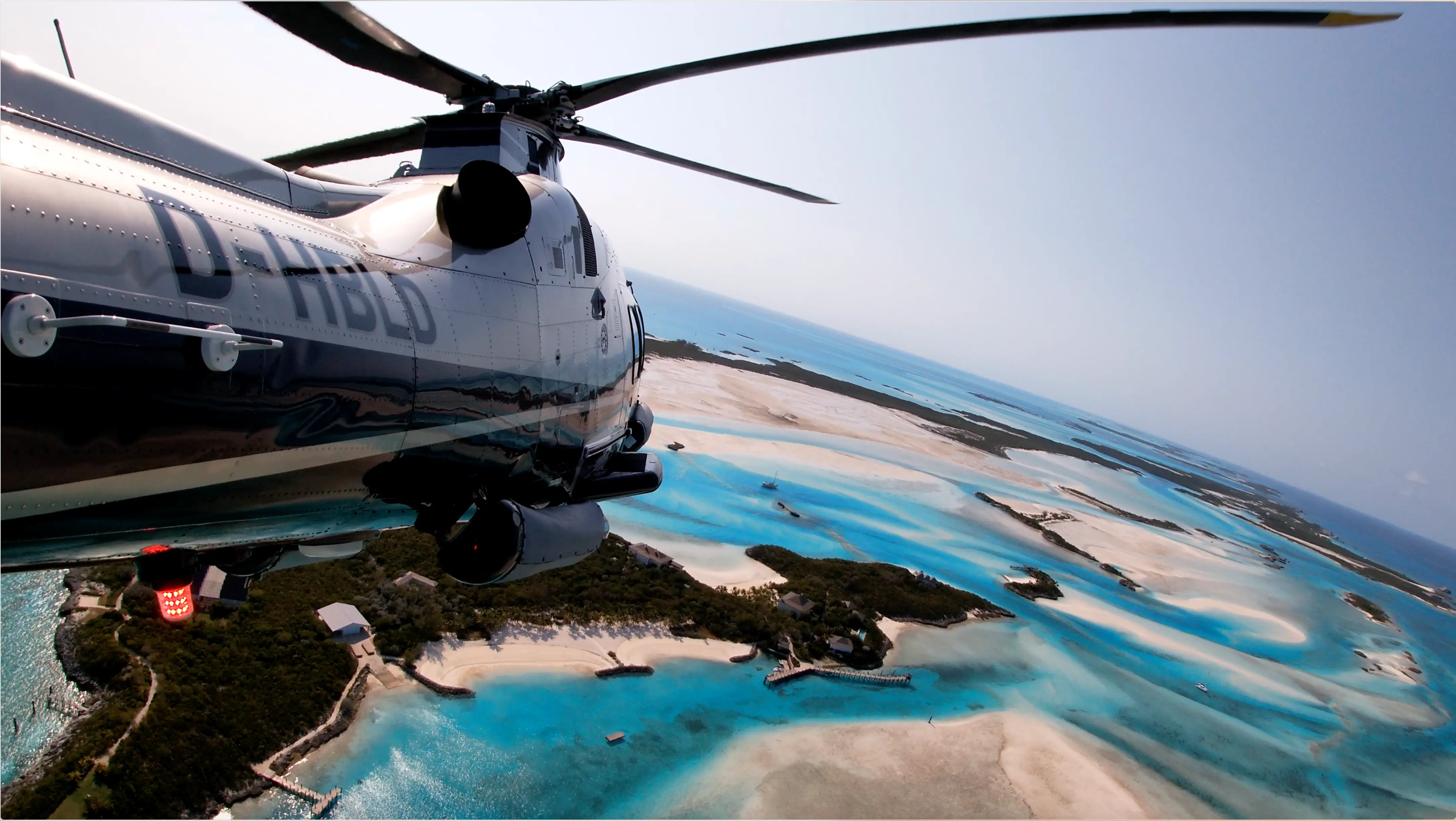 Moody tropical hallway with poufs, arches and lights.