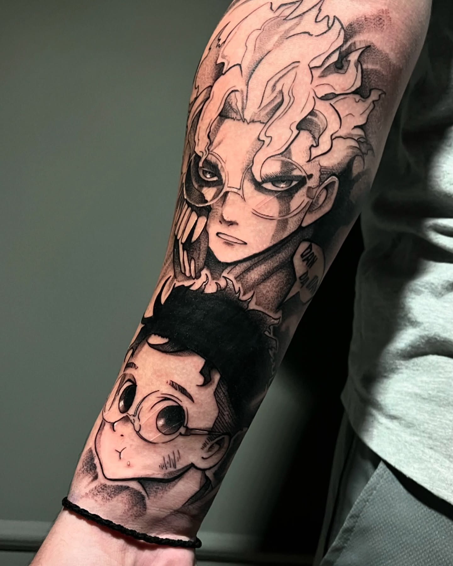 This striking black-and-grey tattoo by SkullBraveTattoo features two forms of Okarun from Dandadan: his unassuming, regular appearance contrasted with his intense, supernatural transformation. The fine shading emphasizes the transition between his personalities, bringing his determination and otherworldly power to life. It's a must-see for fans who love Okarun's character arc.