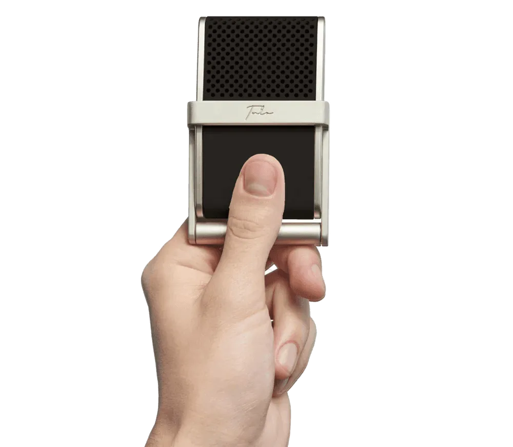 A stylish individual in a black shirt and silver pants stands against a blurred background, creating a dynamic and modern aesthetic.