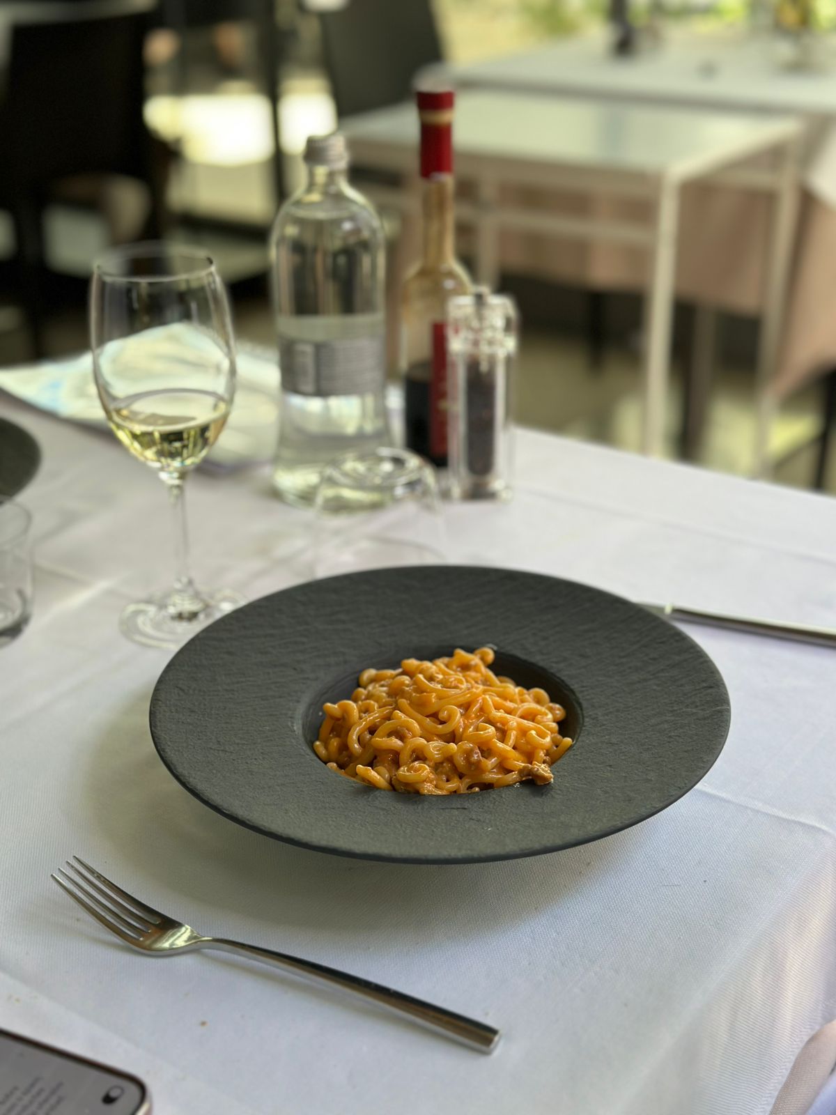 three people sitting in front of table laughing together