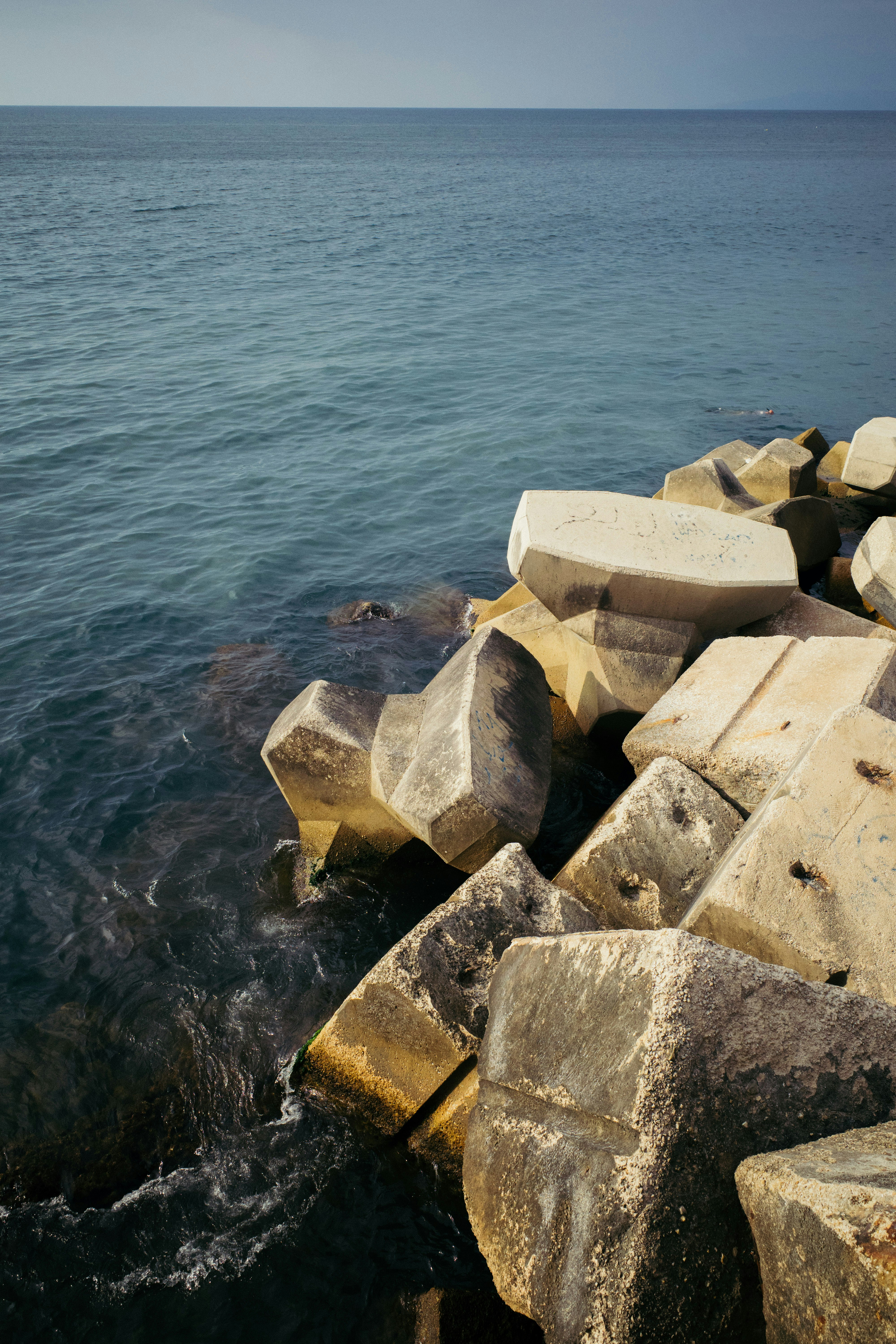 a group of rocks by the water