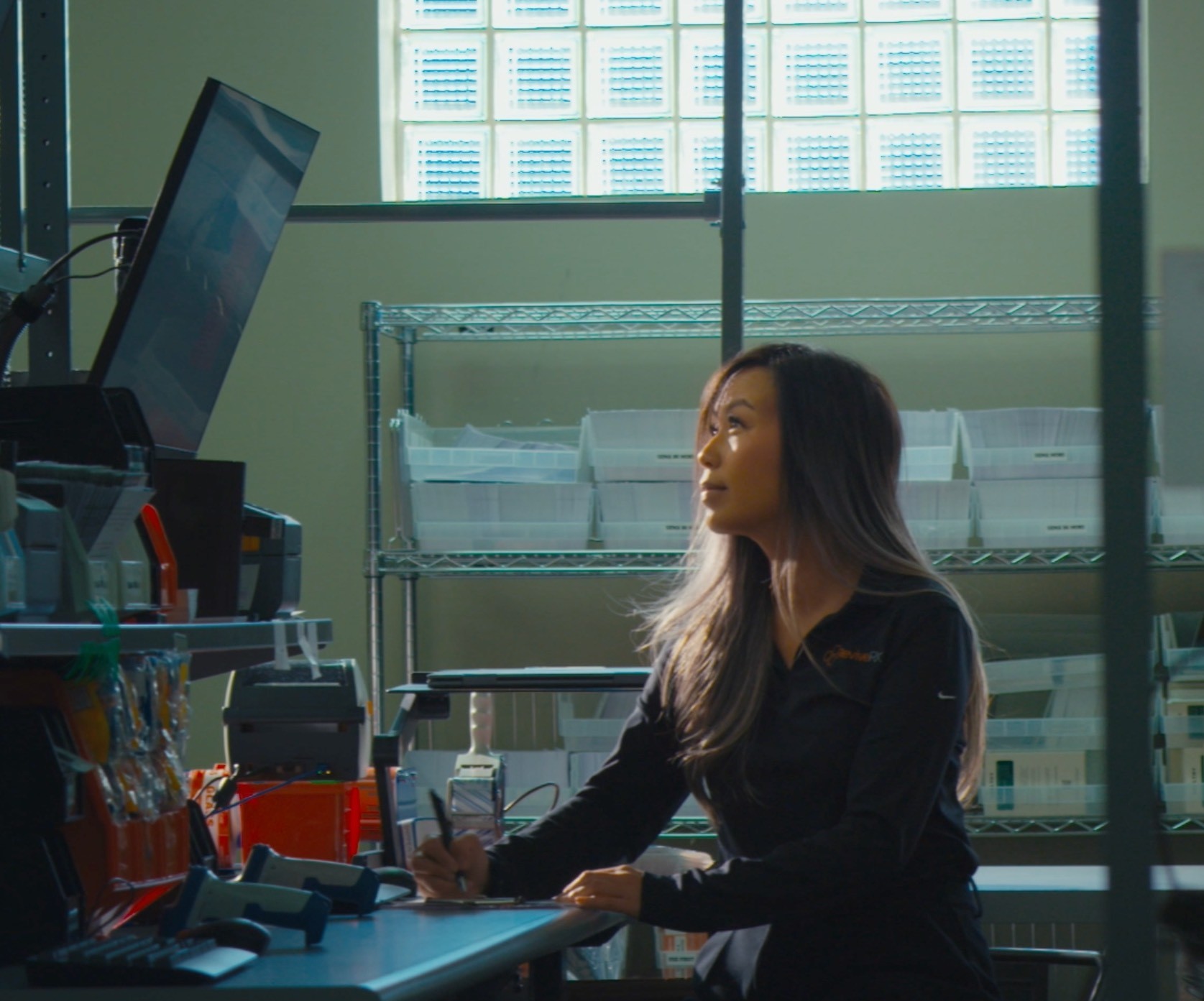 Two pharmacy employees inspecting inventory