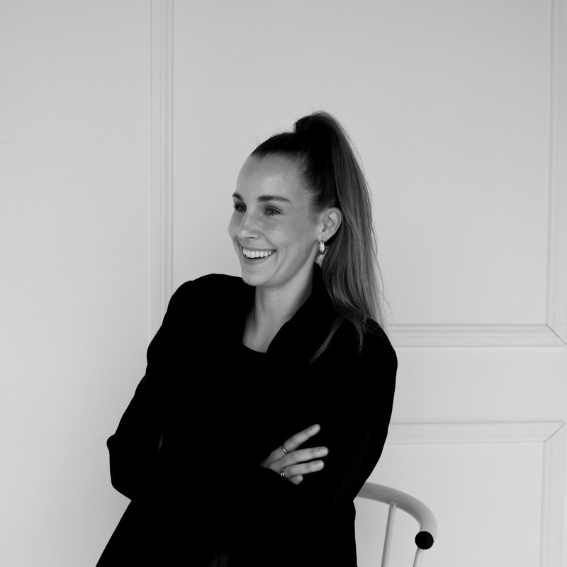 Professional headshot of a person in a formal setting.