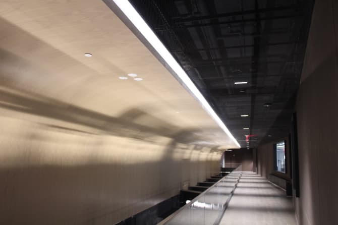 A bright hallway with a large reflective wall