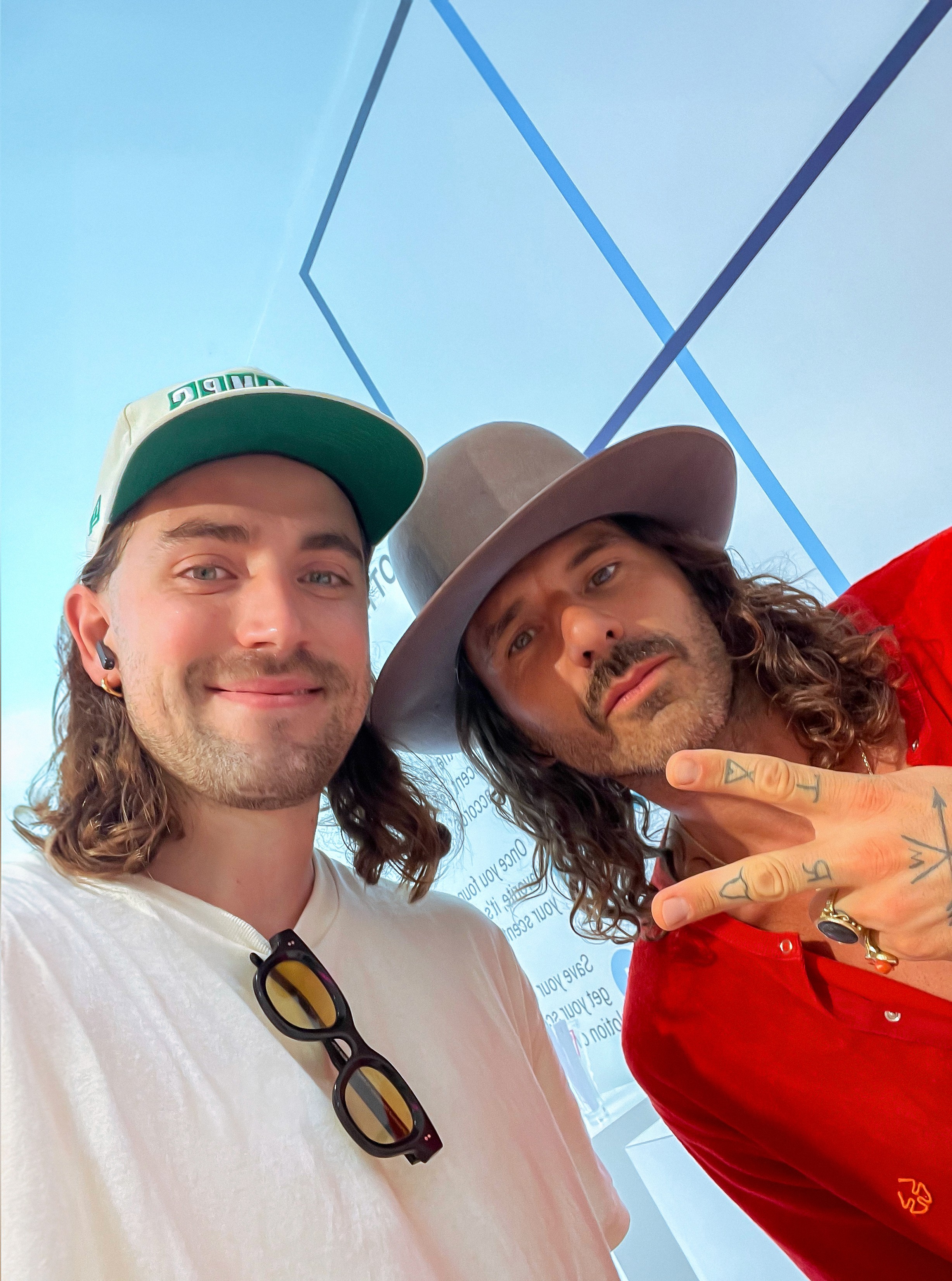 Portrait of a person in a pink sweater against a light background