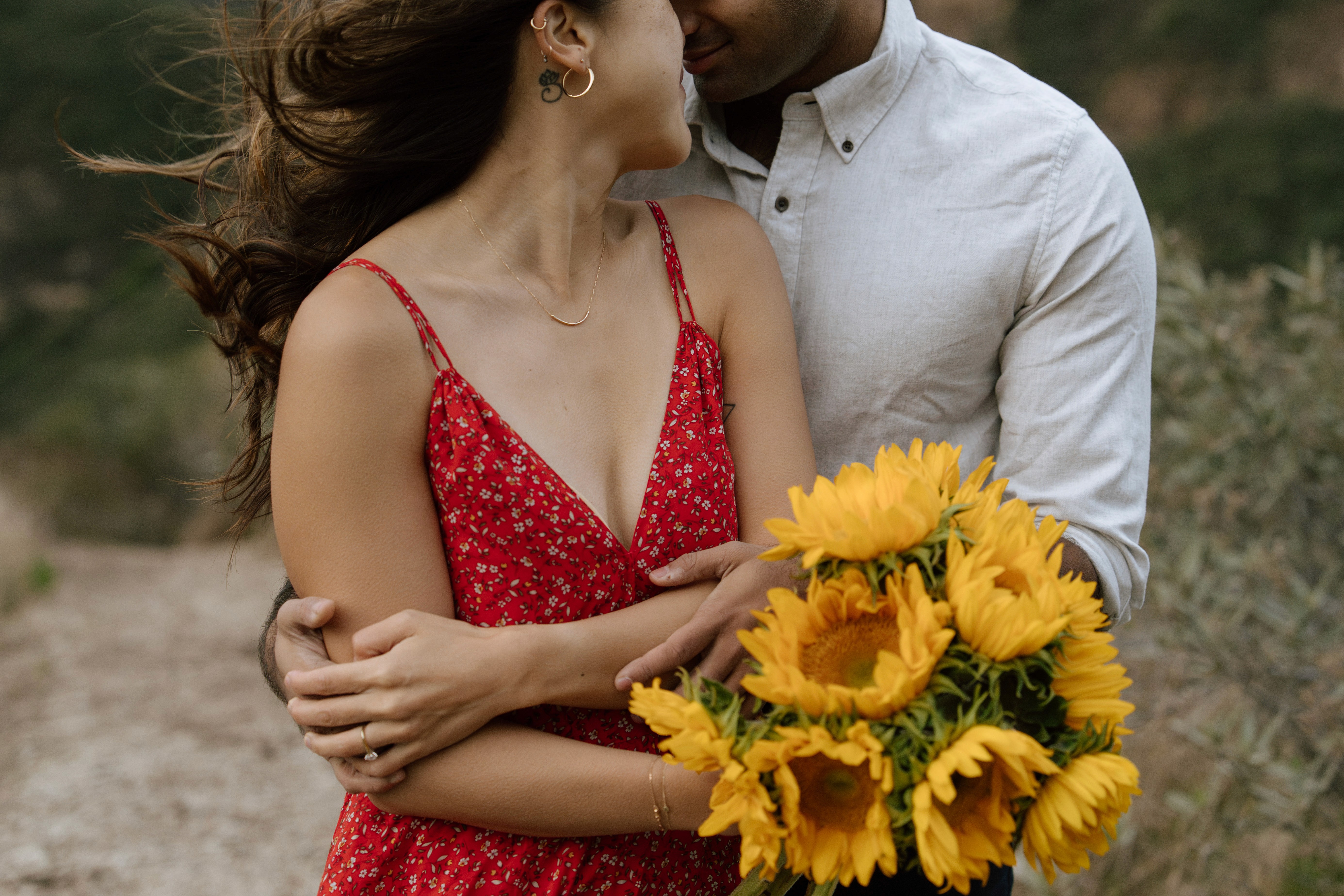 A serene pathway lined with trees leads to a distant building, bathed in warm sunlight.