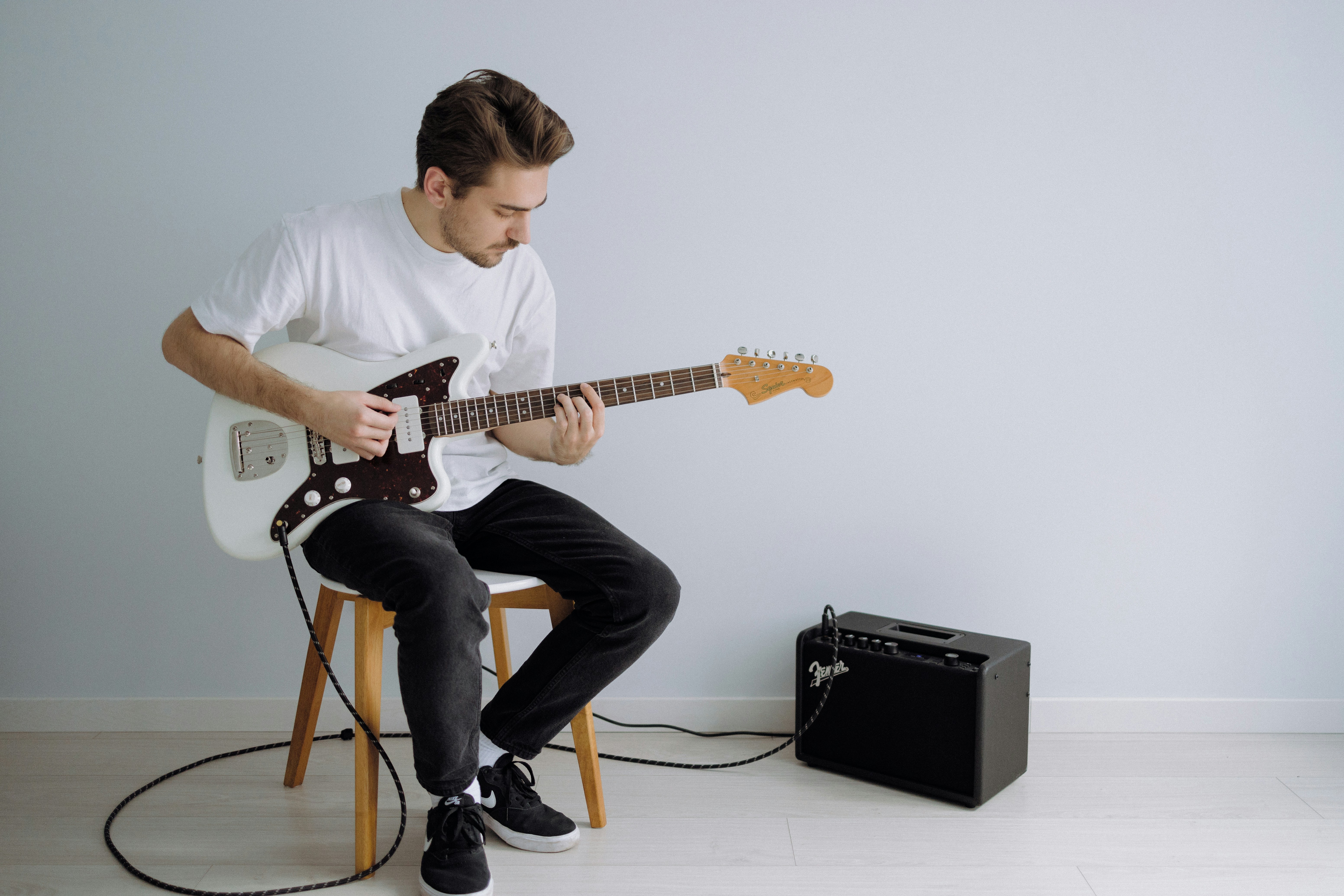 Man fretting a guitar