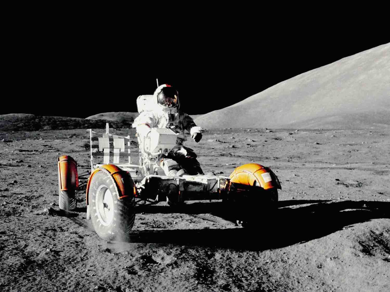 Lunar rover parked on the Moon’s surface with an astronaut nearby