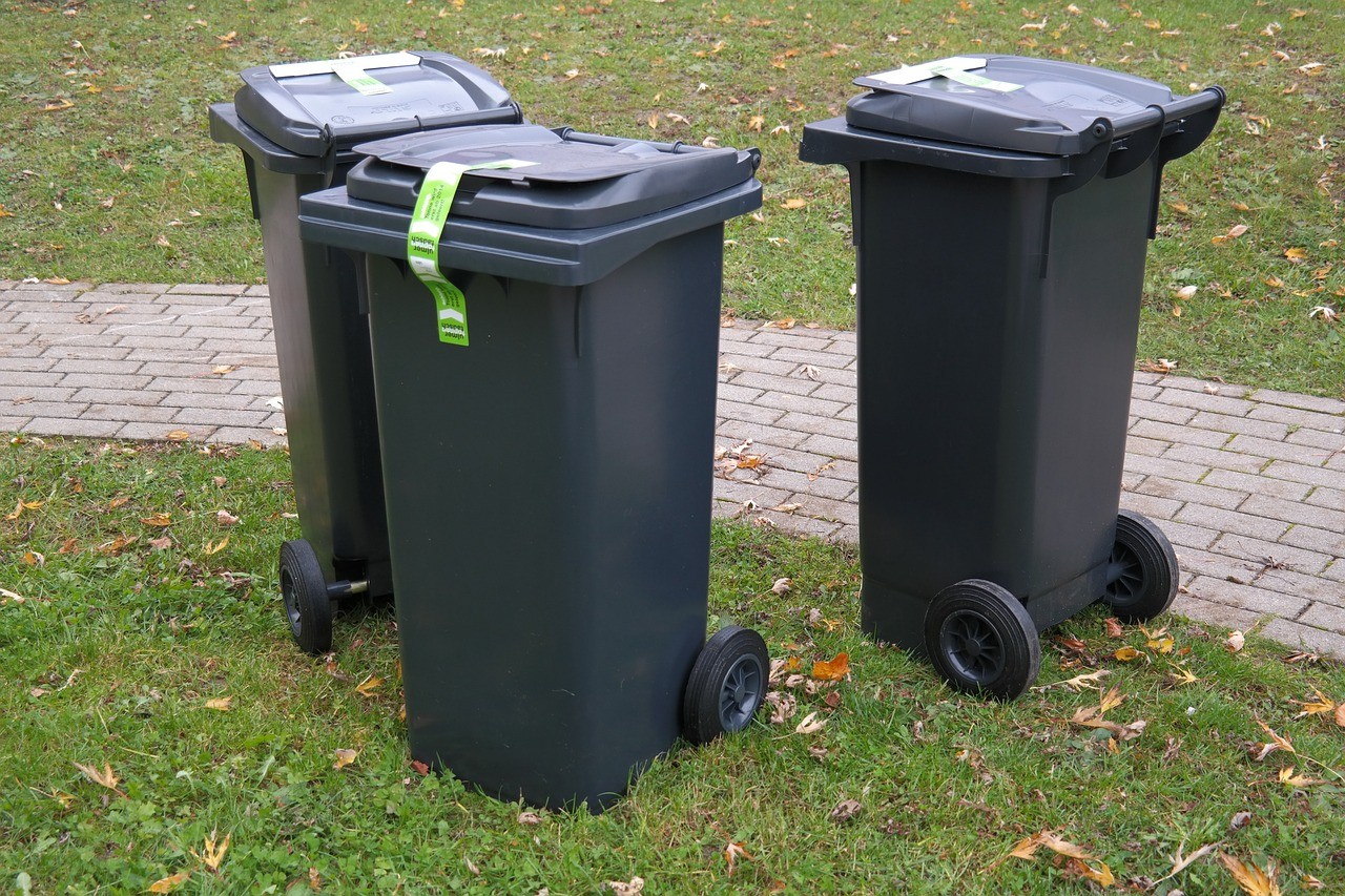 three black wheelie bins in a circle