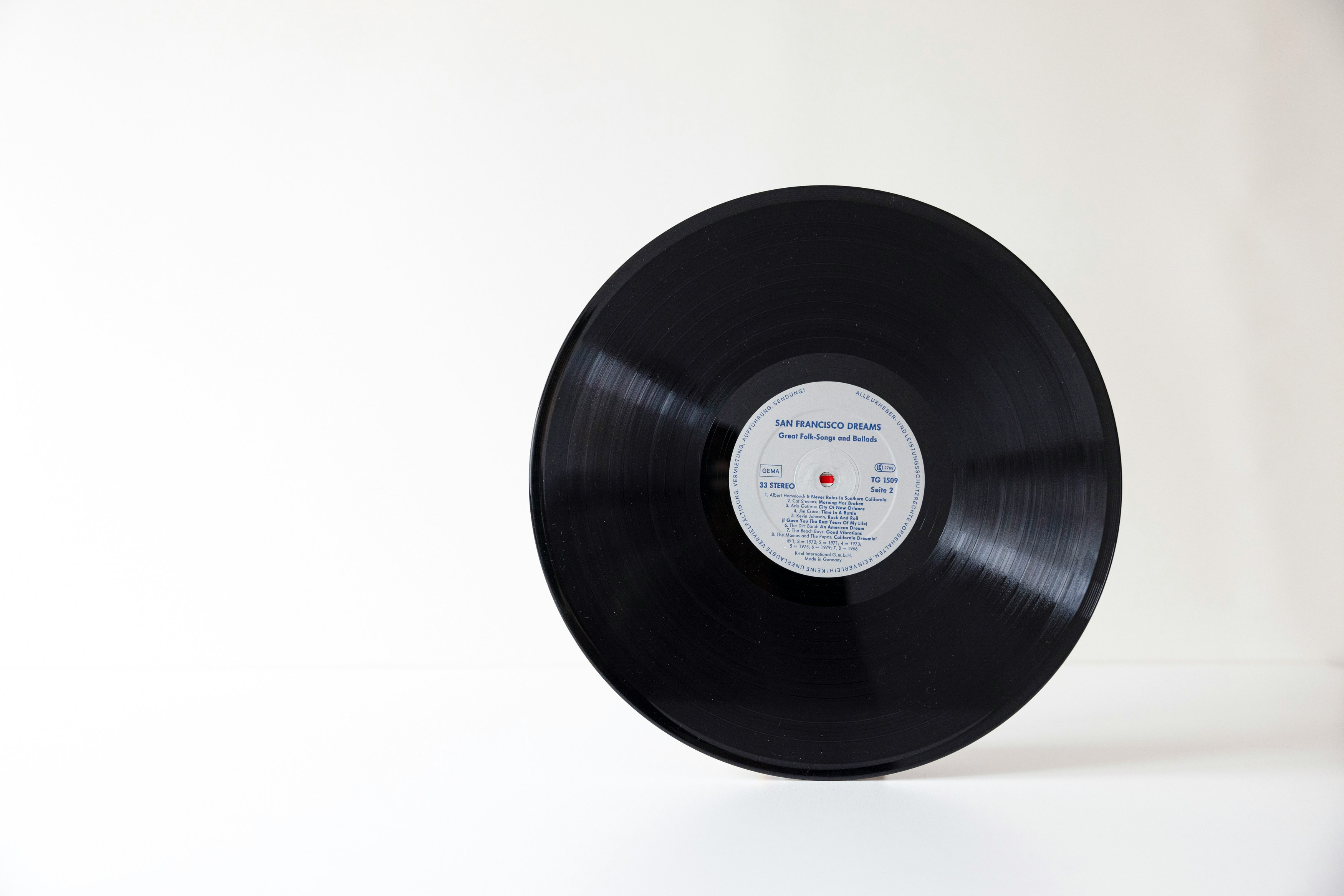 a black vinyl record with a white label on it