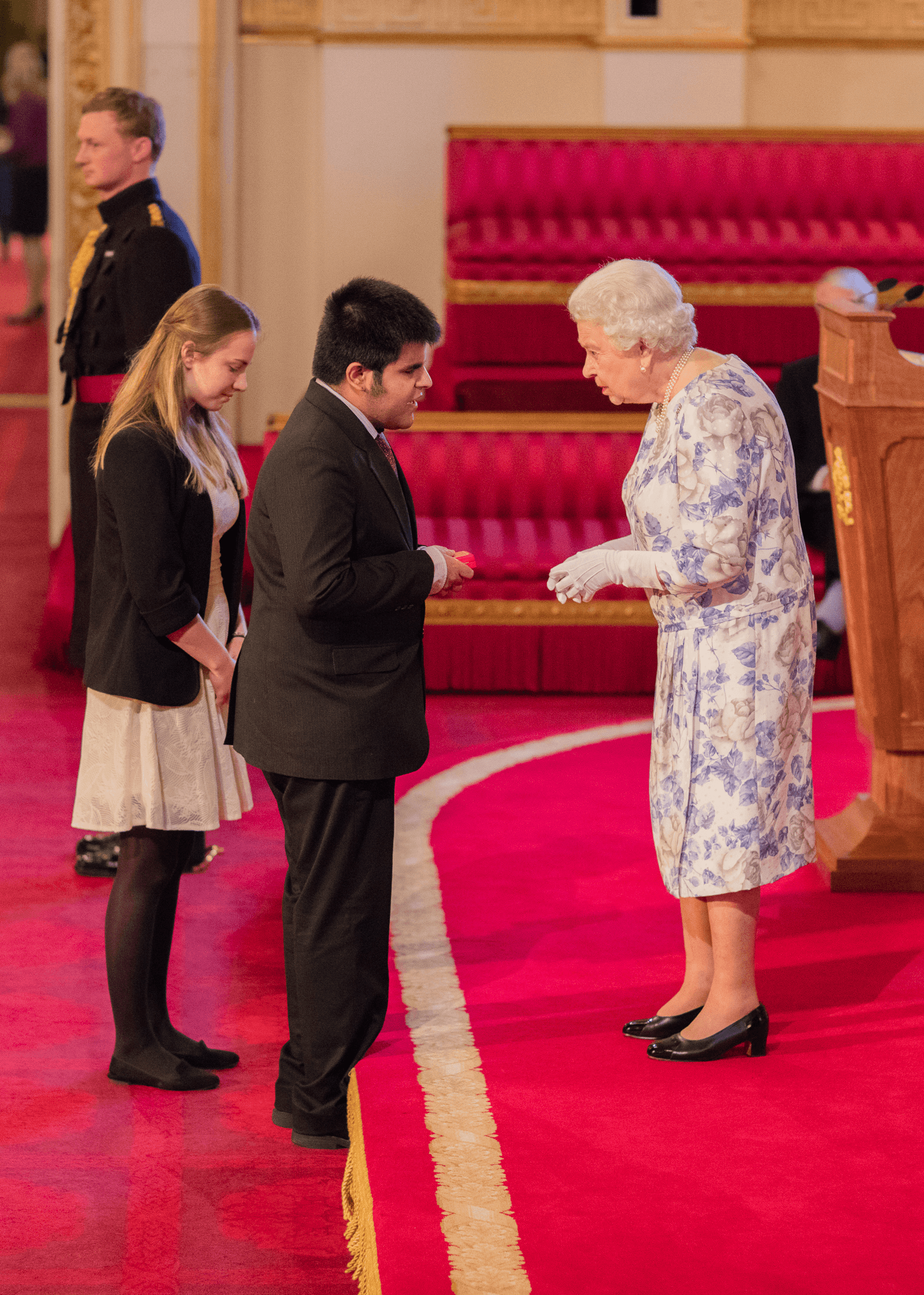 Kartik Sawhney recieving an award from the Queen of England