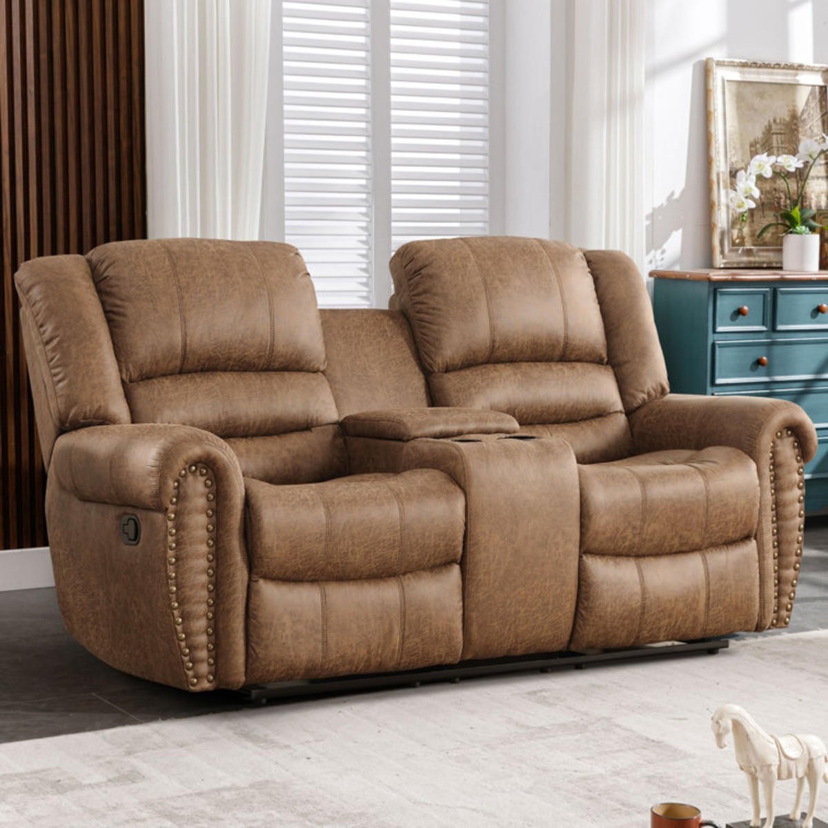 Brown faux leather loveseat with cup holders and storage console.