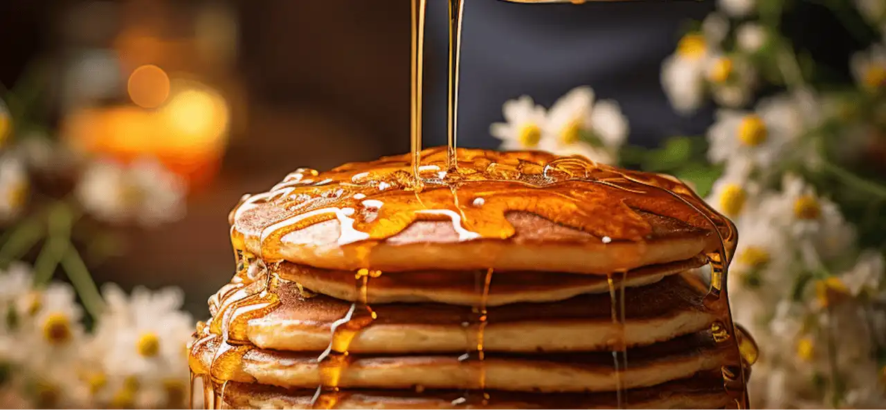 Delicious stack of pancakes with maple syrup dripping over them, breakfast food.