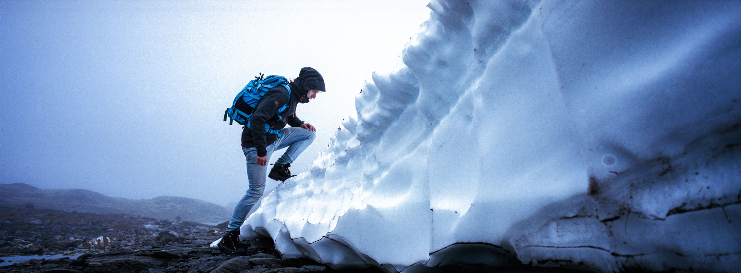 A mountaineer climbing a piece of ice in the mountains of Norway 