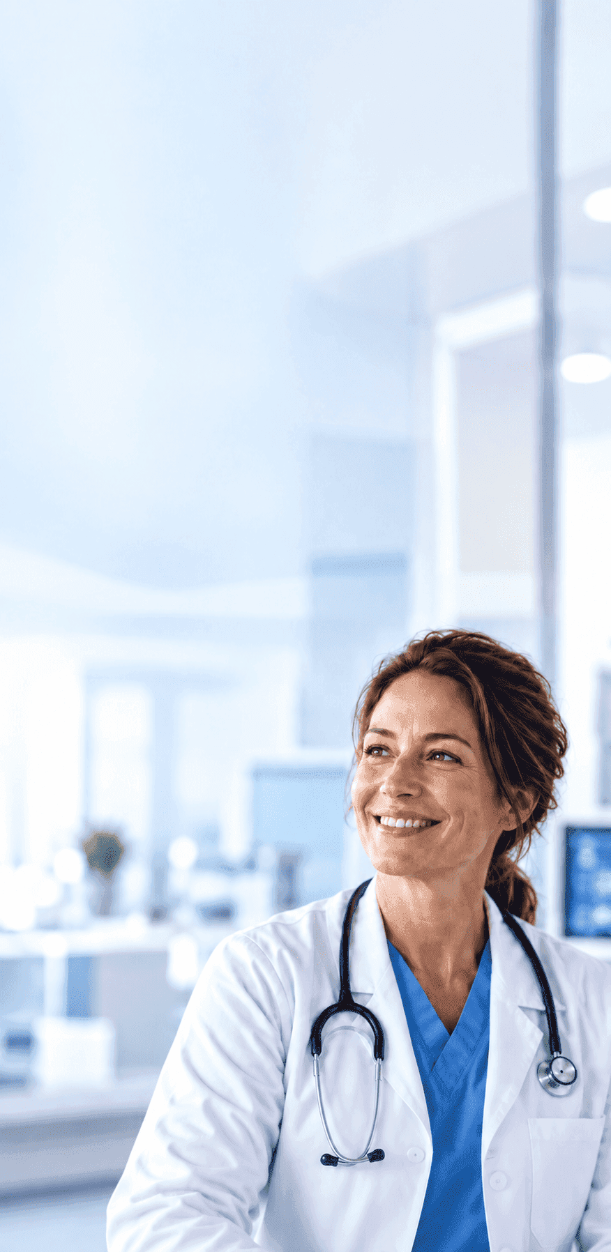 Smiling female doctor with a stethoscope in a bright hospital