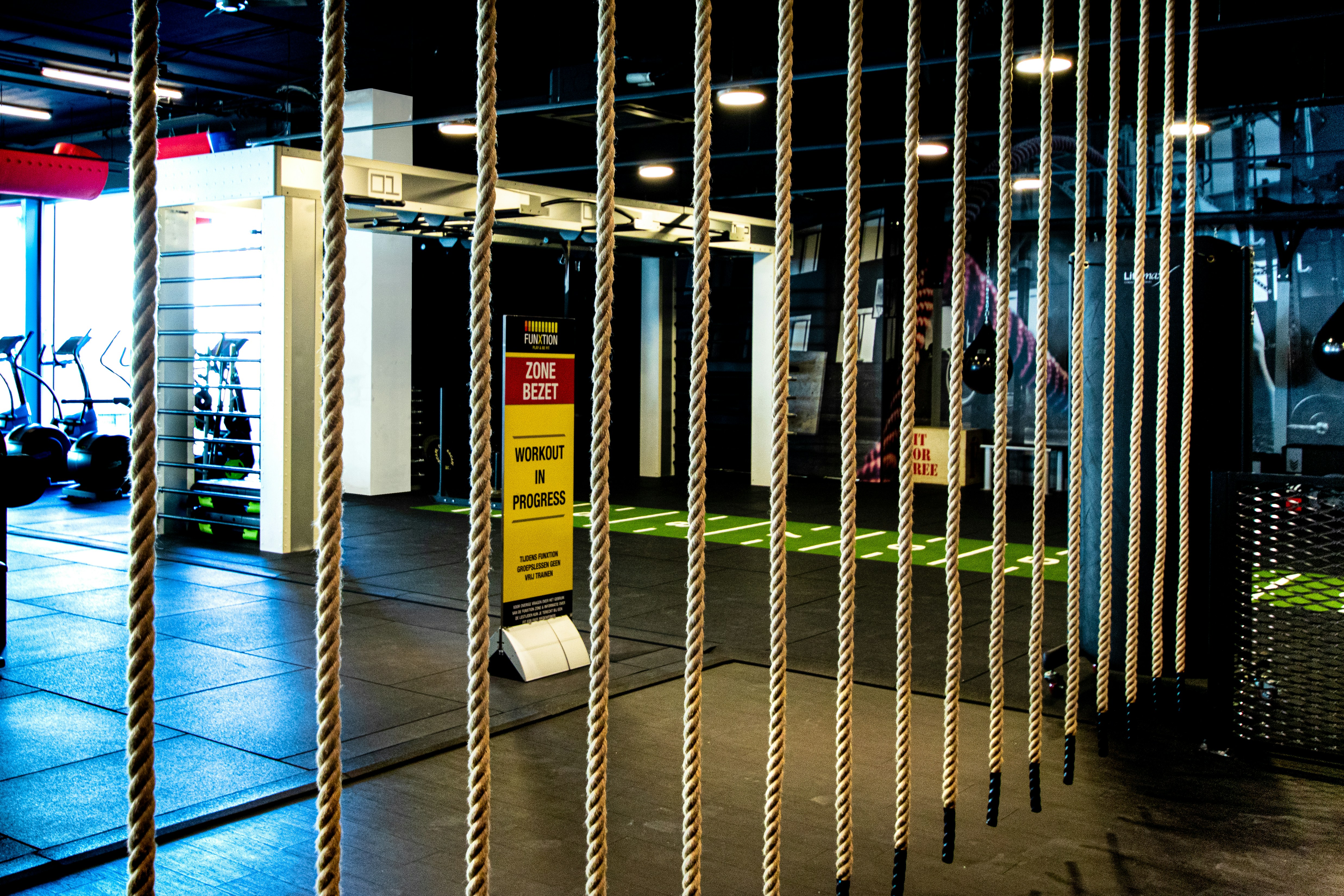 a gym with ropes hanging from the ceiling