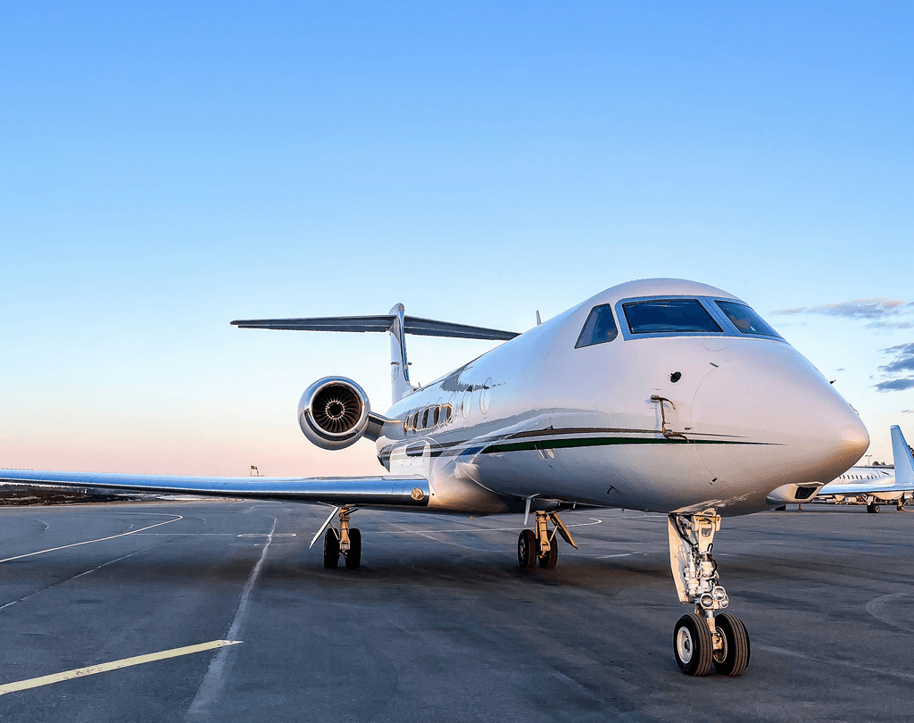 a small white jet sitting on top of an airport tarmac