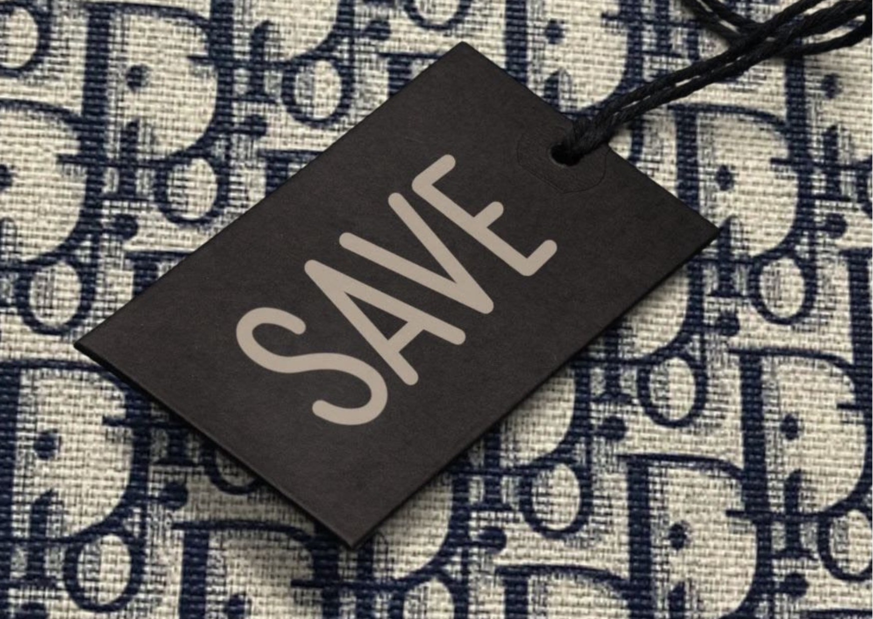 Chic, elegant, classy, stylish, luxurious Dior monogram print in blue on beige canvas fabric with a black tag that says 'save' to signify that shopping at luxury outlets give you authentic, high-quality items at a discount, so good value for money, as they're durable.