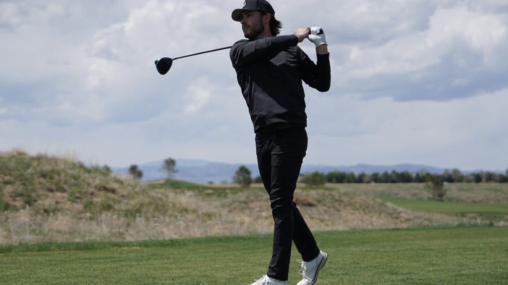 Jax finishing his swing with a driver club.