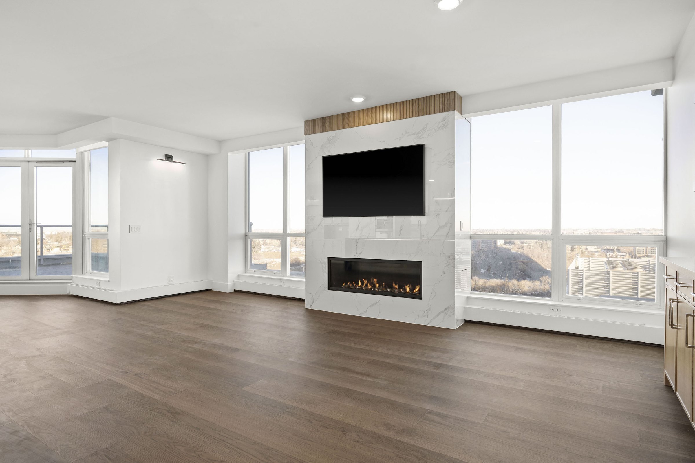 Eau Claire living room after: stone-clad fireplace wall with media niche and new flooring