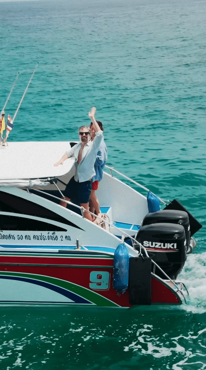 Bride in white dress walking on street, man in background