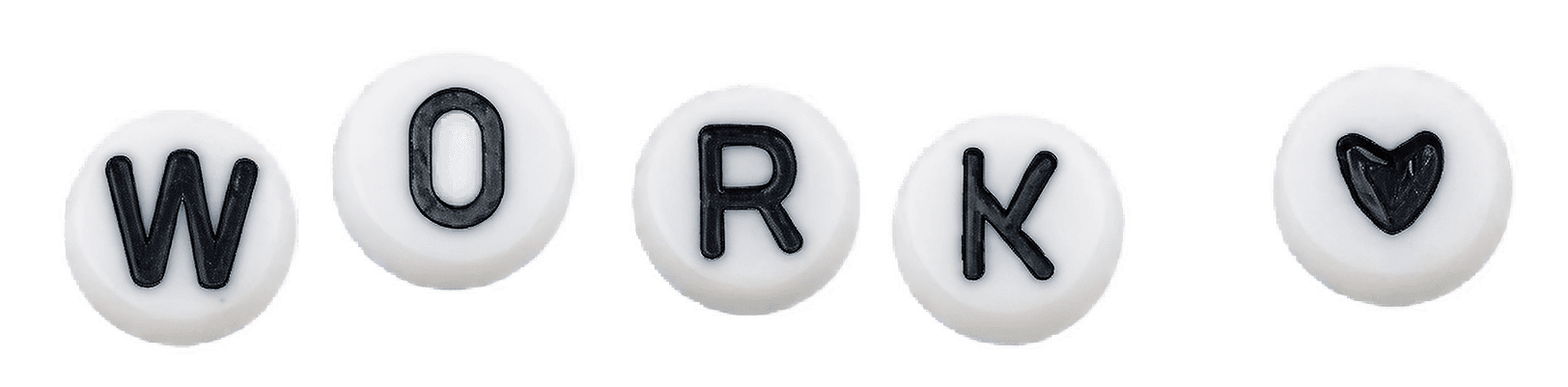 White, round candies each featuring a black letter, spelling the word "WORK" with a heart symbol at the end, on a plain background.