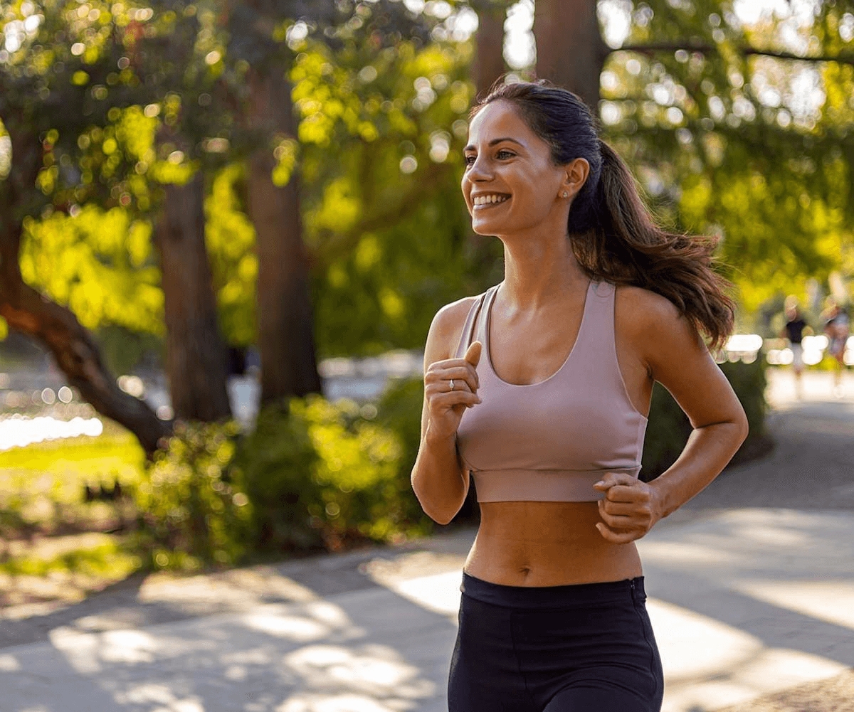A large group photo of diverse team members gathered in an industrial-style space with arched ceiling.