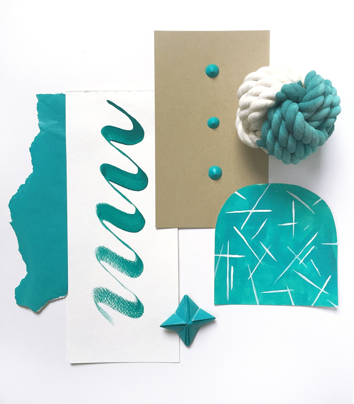 Assemblage of teal: ripped paper, acrylic paint blobs, squiggle, painted half circle with white lines, origami star, and teal and white rope ball