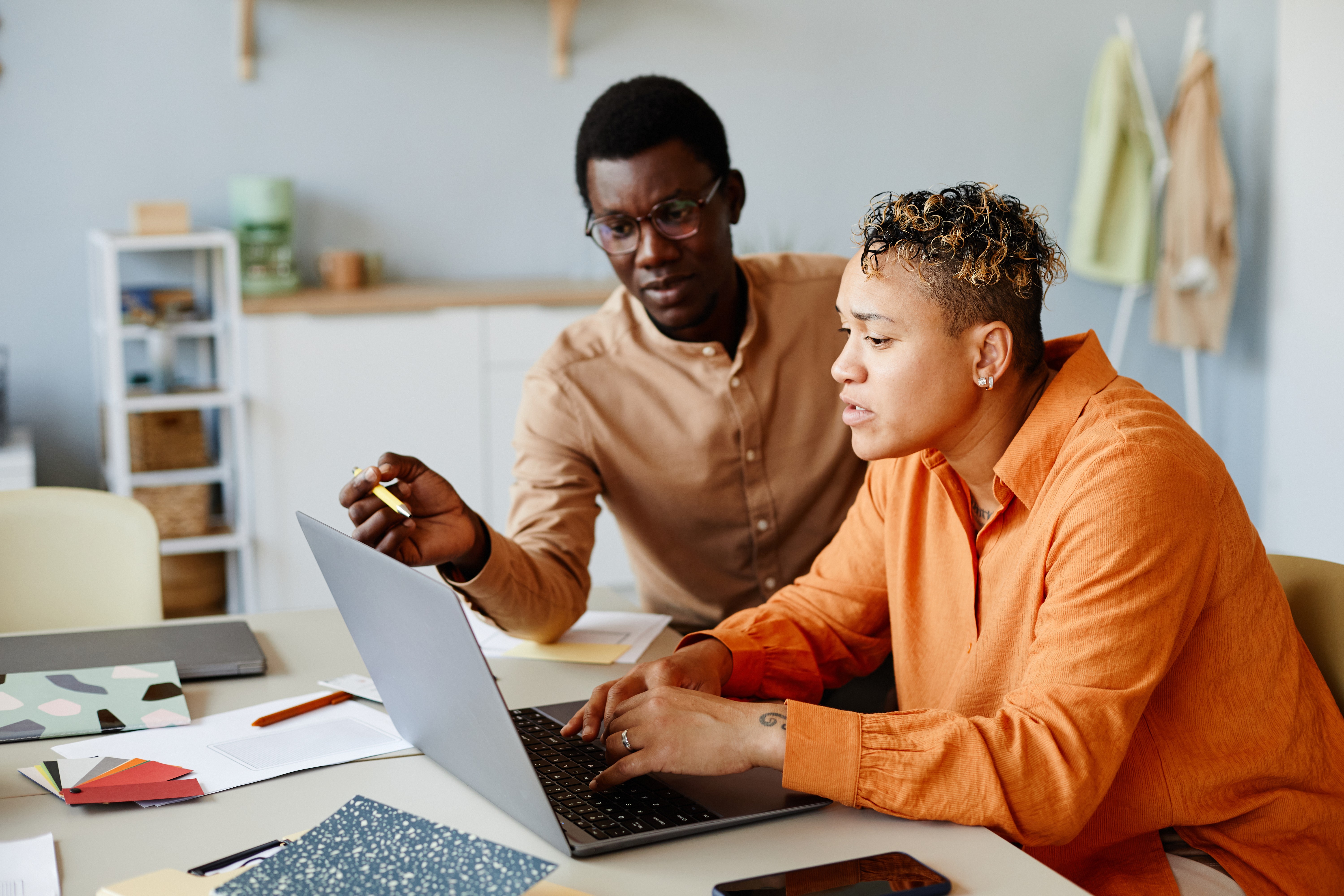 Two colleagues reviewing cloud billing data on a laptop