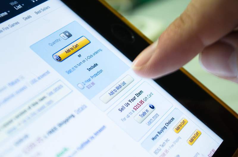 close-up of someone adding product to cart