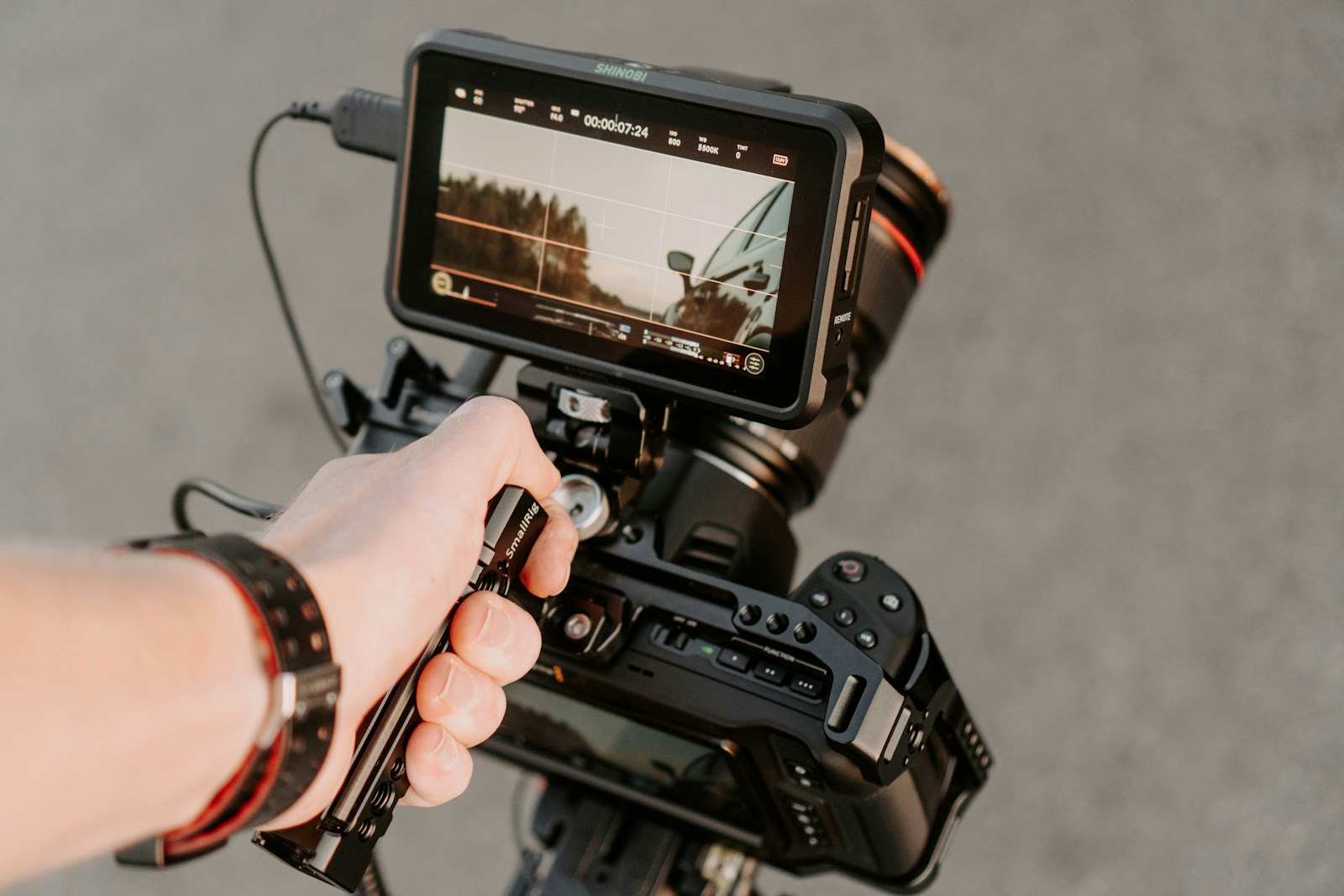 Person holding black dslr camera