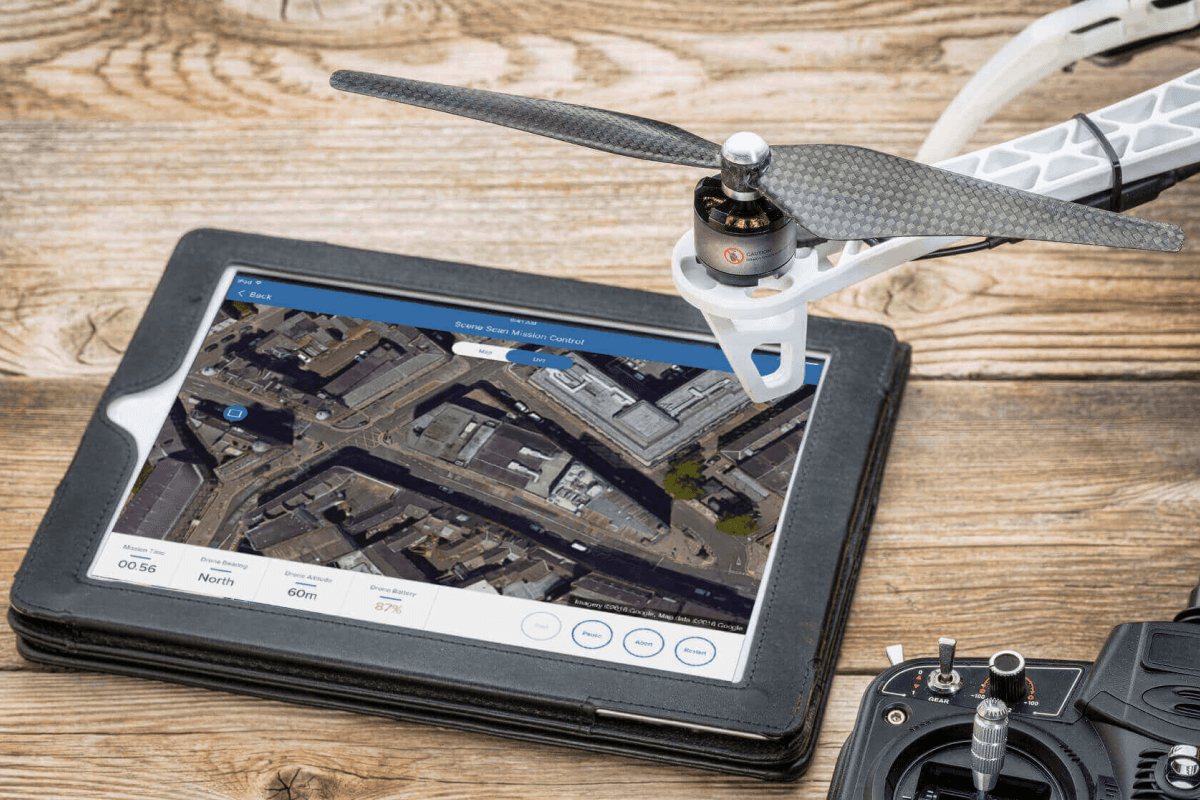 A tablet showing the streets from an aerial view, with a drone next to it