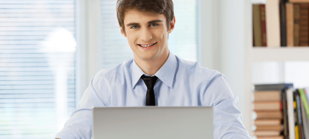 Man smiling in front of his computer