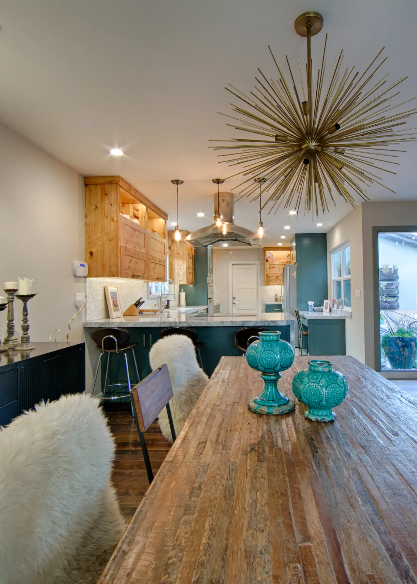 Dining area with modern table, bench seating, and view into kitchen in Huntington Beach Kitchen & Bath Remodel.