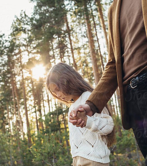 A rustic outdoor market stall displays an array of fresh produce including vibrant tomatoes, leafy greens, and a variety of olives, set against the backdrop of a picturesque rural Italian village.