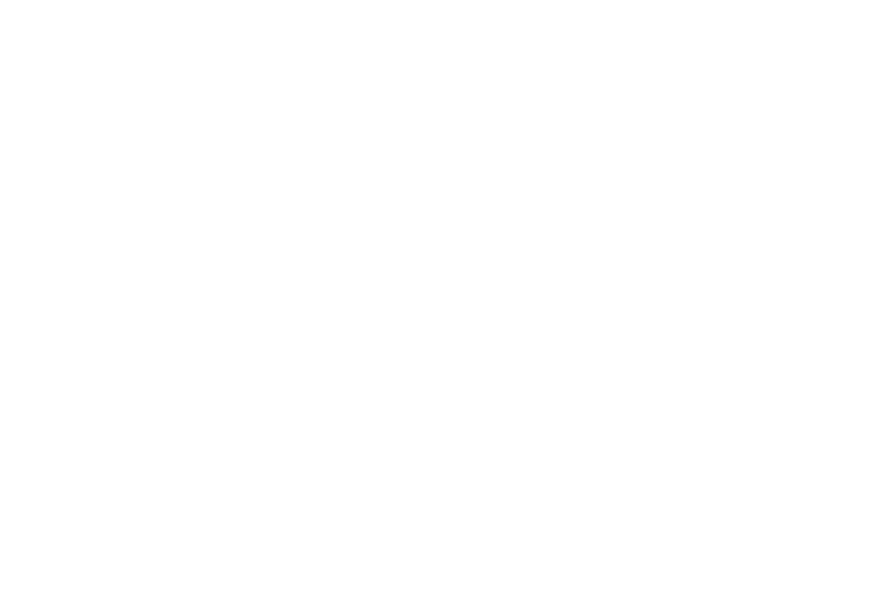A person stands in a sandstone cave.