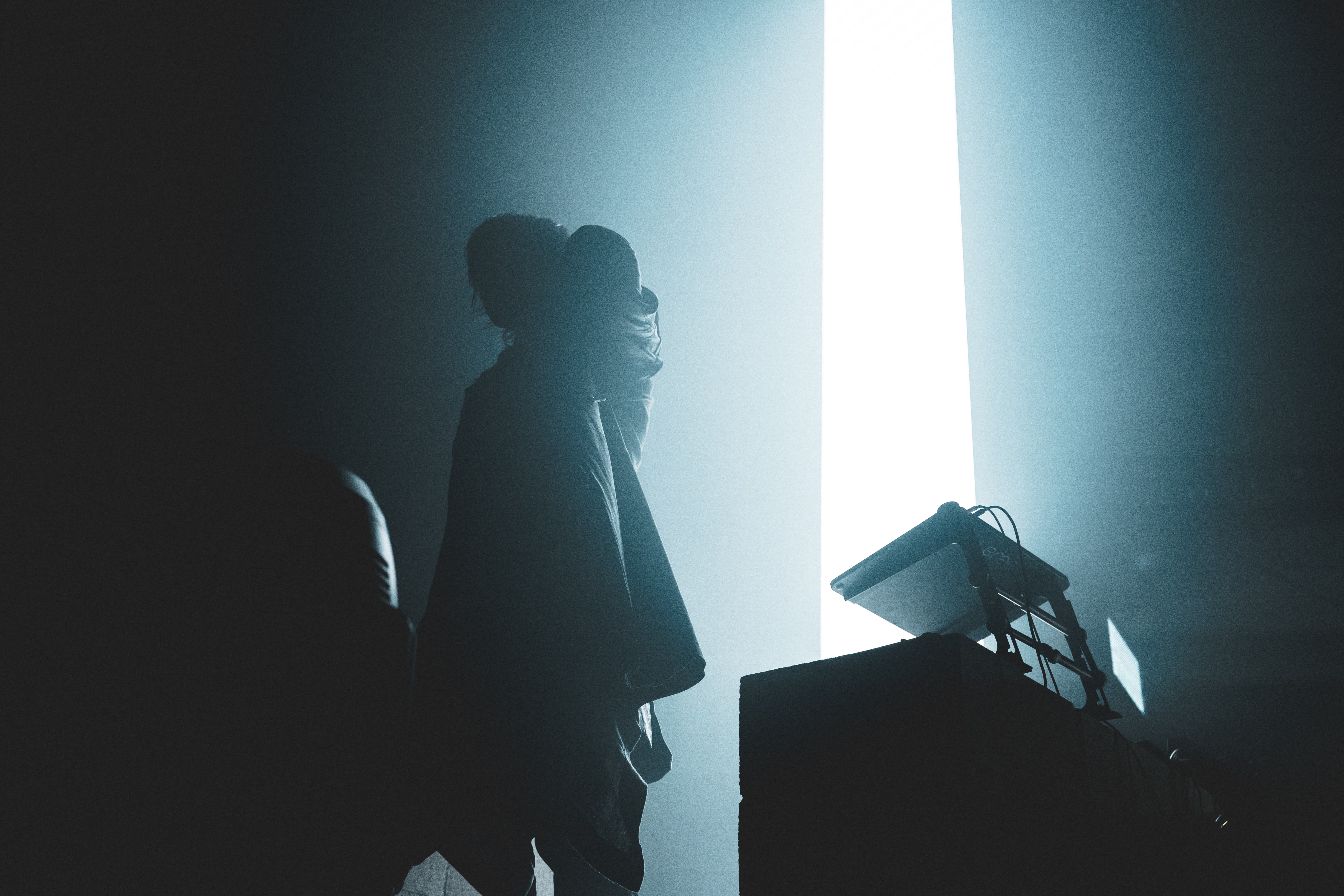 pluko performing live at Don Quixote Los Angeles, silhouette against stage haze captured by A World Away