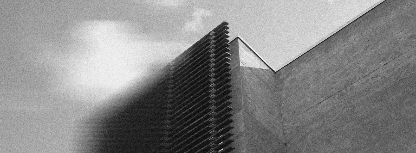 two-story front house with a concrete exterior and warm interior design, epitomizing modern Key West accommodations