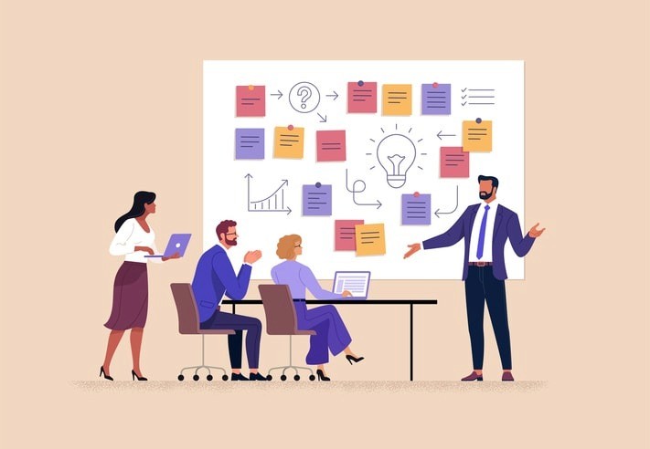 A group of diverse team members discussing a project led by a team leader.
