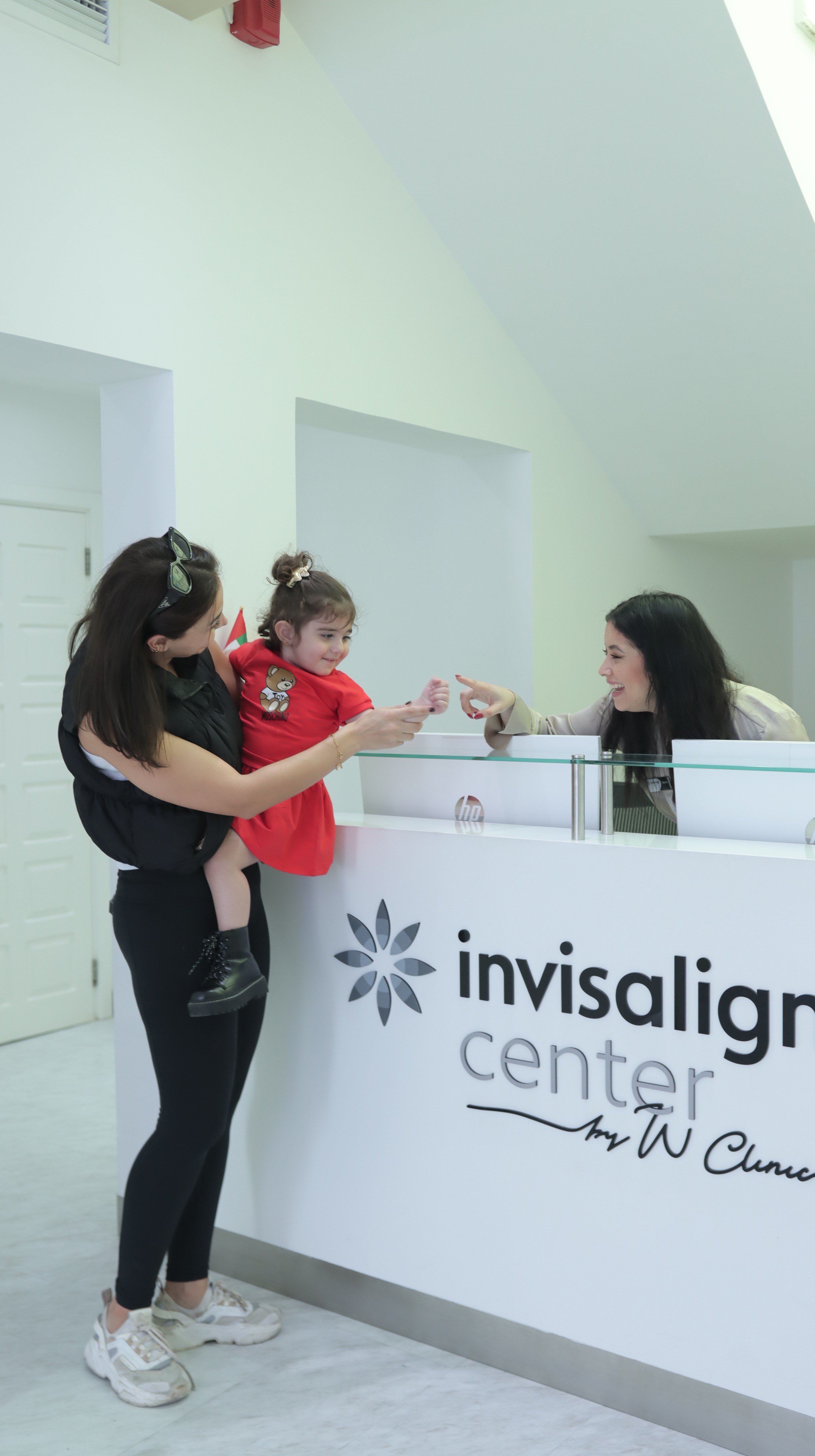 Friendly pediatric dentist welcomes child in a calm, soothing clinic, ensuring a comfortable and stress-free dental visit.