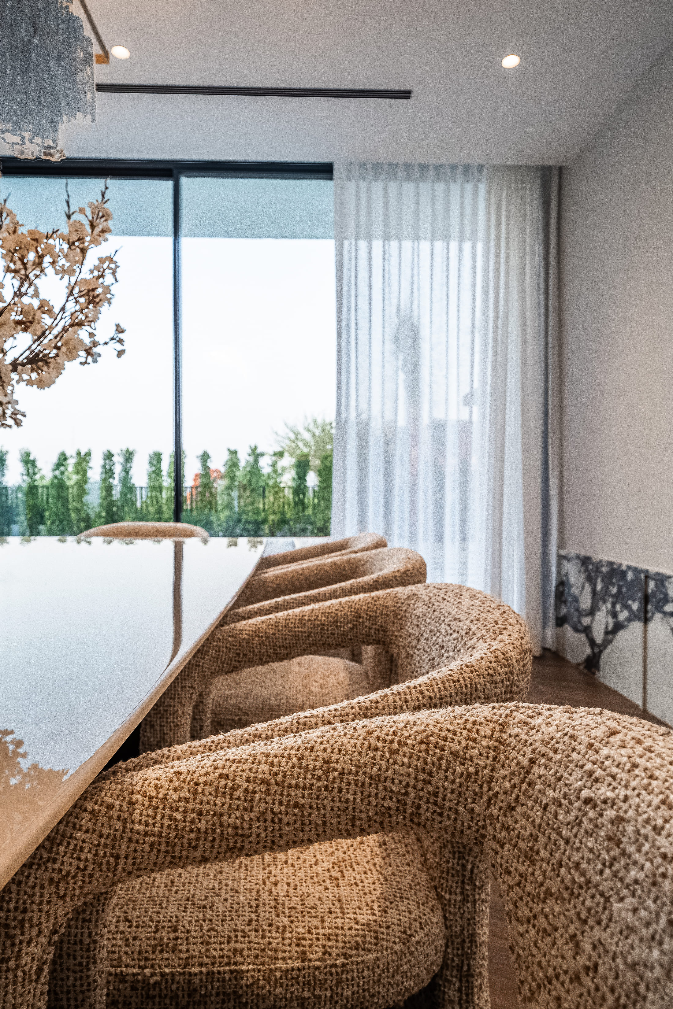 Image of a dinning setup and a big window 