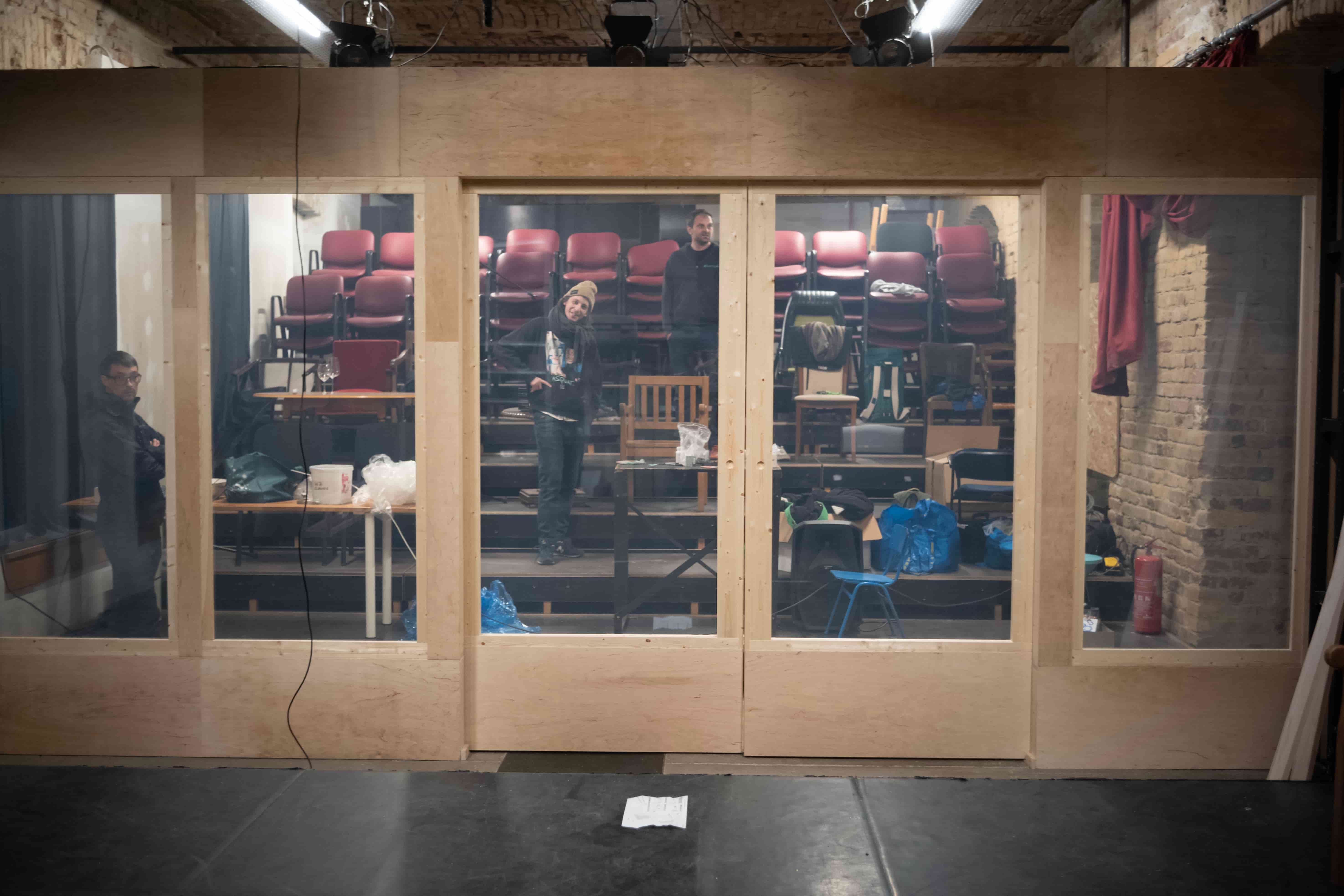 A person stands in a sandstone cave.