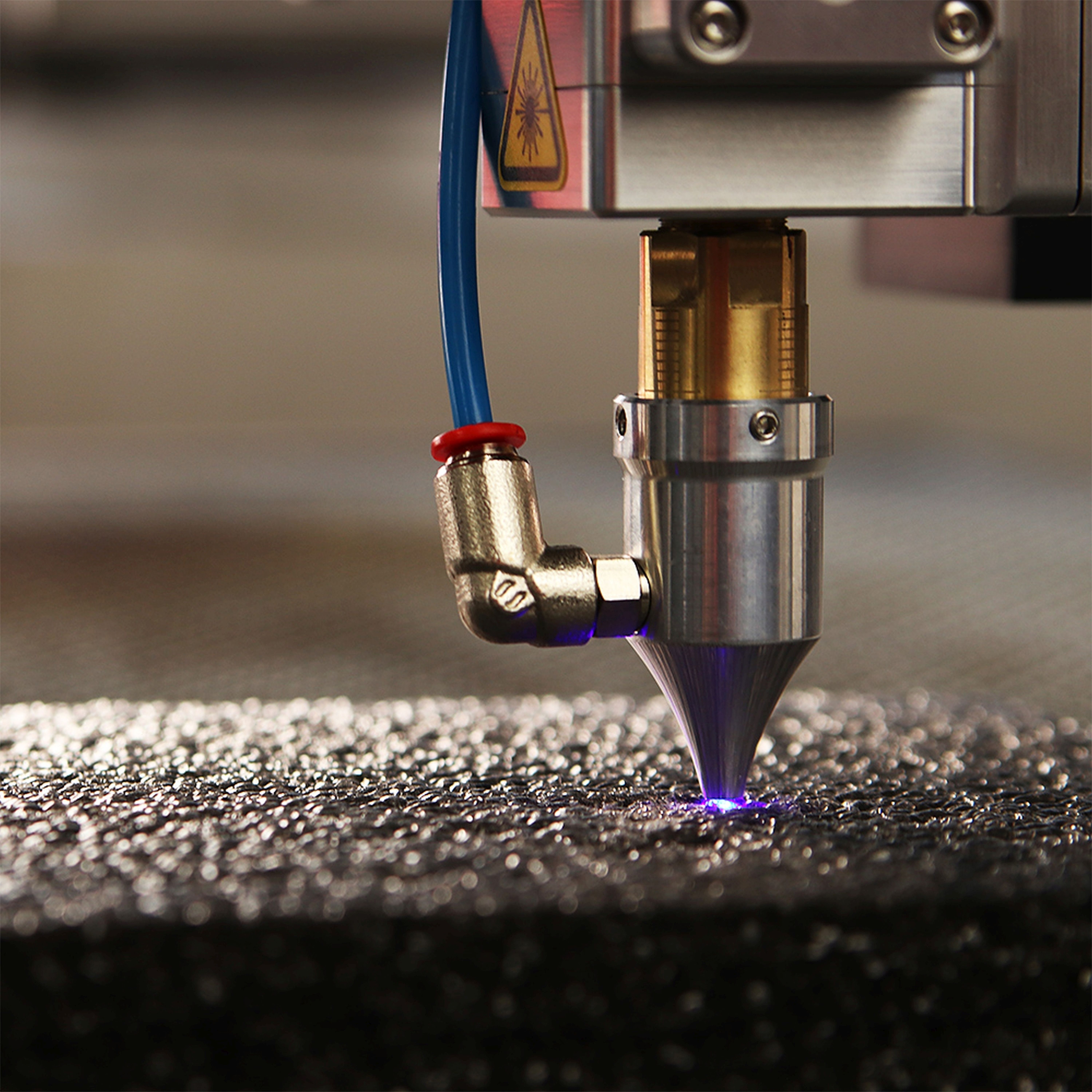 A machine that is cutting a piece of metal