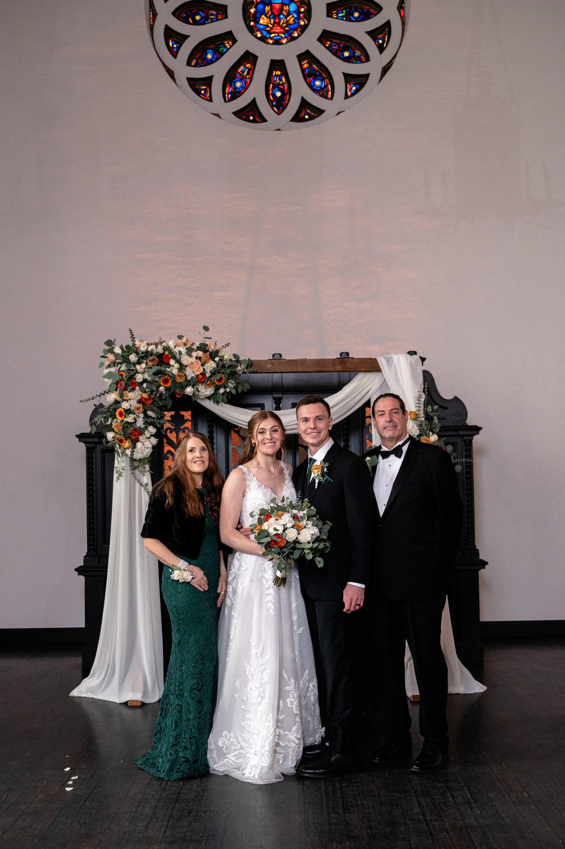 Flat lay wedding details with bouquet, rings, and sparkling bridal heels