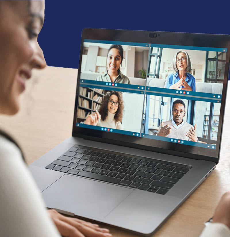 Person using a laptop to participate in a video call with multiple people displayed on the screen