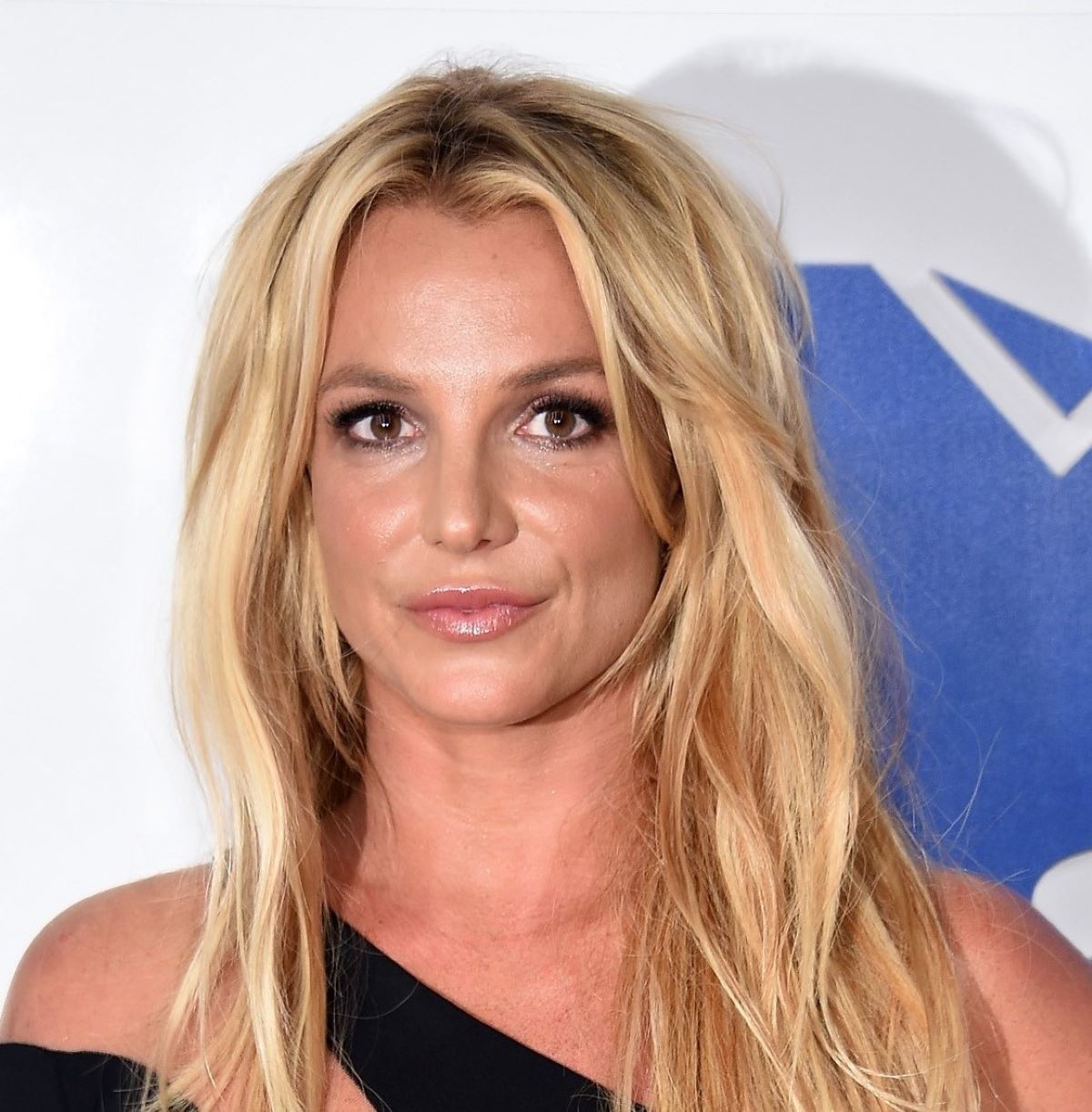 man wearing green crew-neck top and eyeglasses with black frames looking at side